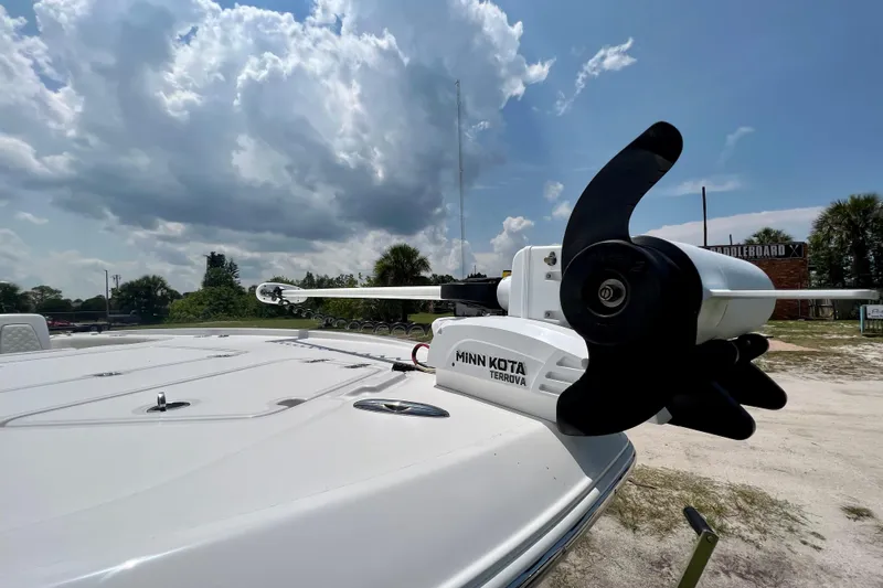  Yacht Photos Pics 2020 Caymas 28 HB boat with Minn Kota Terrova motor under a cloudy sky.