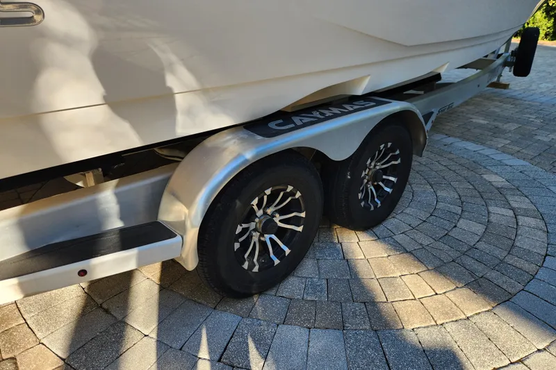  Yacht Photos Pics 2020 Caymas 28 HB boat on trailer with stylish wheels, parked on circular stone pavement.