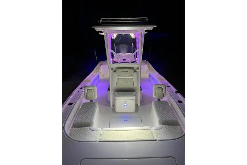  Yacht Photos Pics 2020 Caymas 28 HB boat interior with illuminated seating and console at night.