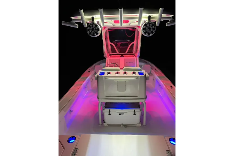  Yacht Photos Pics 2020 Caymas 28 HB boat interior with vibrant LED lighting and fishing rod holders.