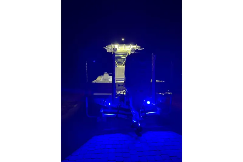  Yacht Photos Pics 2020 Caymas 28 HB boat illuminated with blue lights at night.