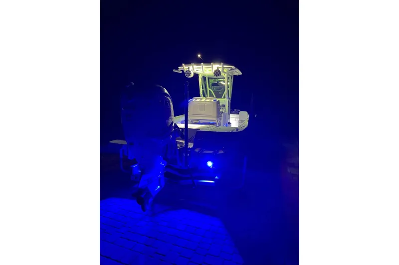  Yacht Photos Pics 2020 Caymas 28 HB boat illuminated with blue and white lights at night.