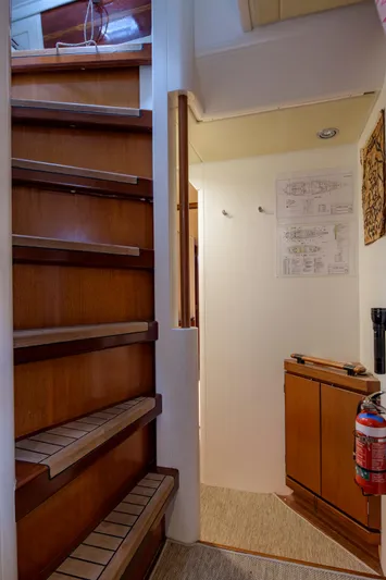 Billy Budd II Yacht Photos Pics Interior of 1994 Royal Huisman 112' Custom yacht with wooden stairs and hallway.