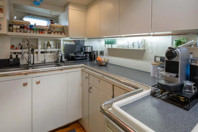 Billy Budd II Yacht Photos Pics Luxurious yacht kitchen with modern appliances, sleek countertops, and ample storage. Royal Huisman 112' Custom, 1994.