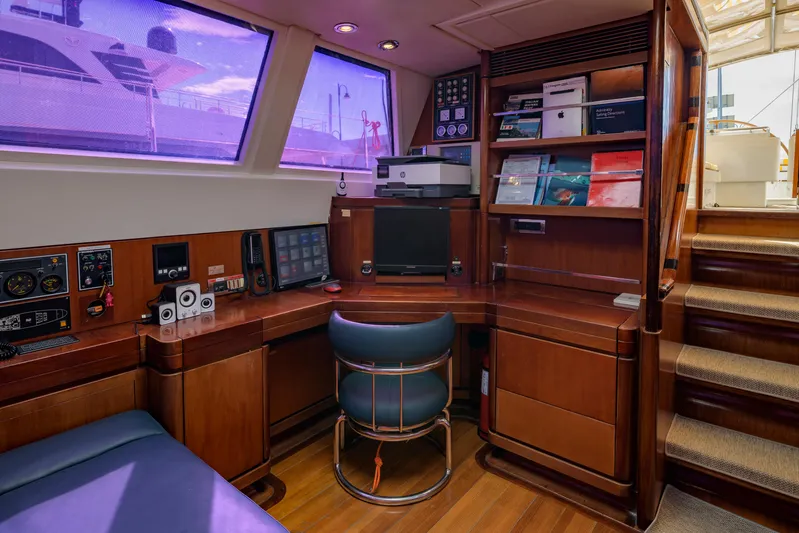 Billy Budd II Yacht Photos Pics Luxurious yacht interior with wooden desk, chair, and shelves on a 1994 Royal Huisman 112' Custom.