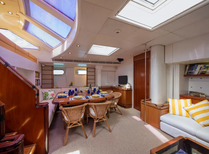 Billy Budd II Yacht Photos Pics Luxurious interior of 1994 Royal Huisman 112' Custom yacht with elegant dining area and skylights.