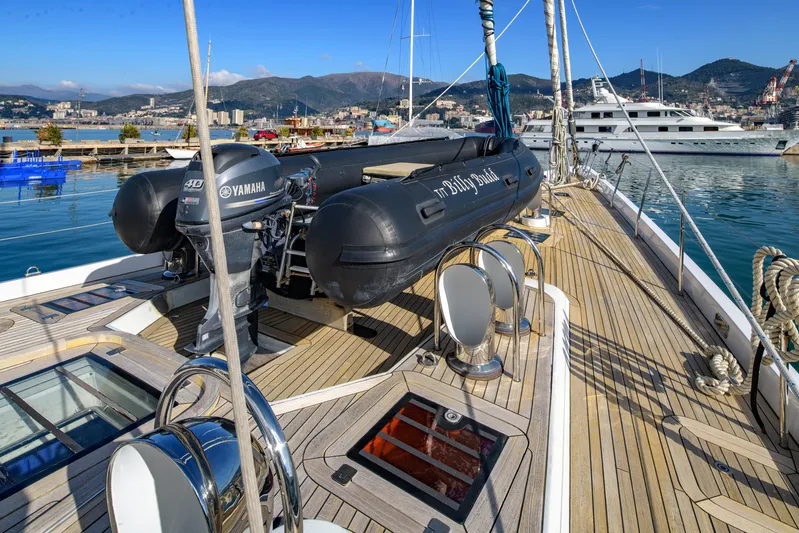 Billy Budd II Yacht Photos Pics Royal Huisman 112' Custom yacht deck with tender, docked in scenic marina, 1994 model.