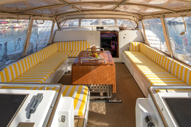 Billy Budd II Yacht Photos Pics Luxurious 1994 Royal Huisman 112' Custom yacht interior with striped seating and elegant table.