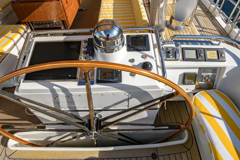 Billy Budd II Yacht Photos Pics Cockpit of 1994 Royal Huisman 112' Custom yacht with wooden wheel and navigation instruments.