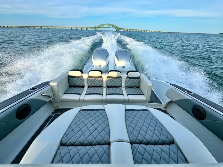  Yacht Photos Pics Luxury 2019 Statement 350 Open boat cruising with twin engines, bridge in background.