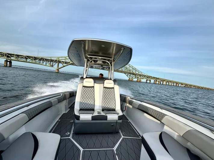  Yacht Photos Pics 2019 Statement 350 Open boat cruising near a bridge on a sunny day.