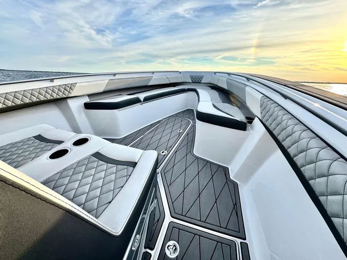  Yacht Photos Pics Luxurious 2019 Statement 350 Open boat interior with quilted seating and ocean view at sunset.
