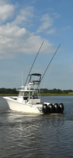  Yacht Photos Pics 2022 Front Runner 39 Center Console boat with four engines on a calm lake.