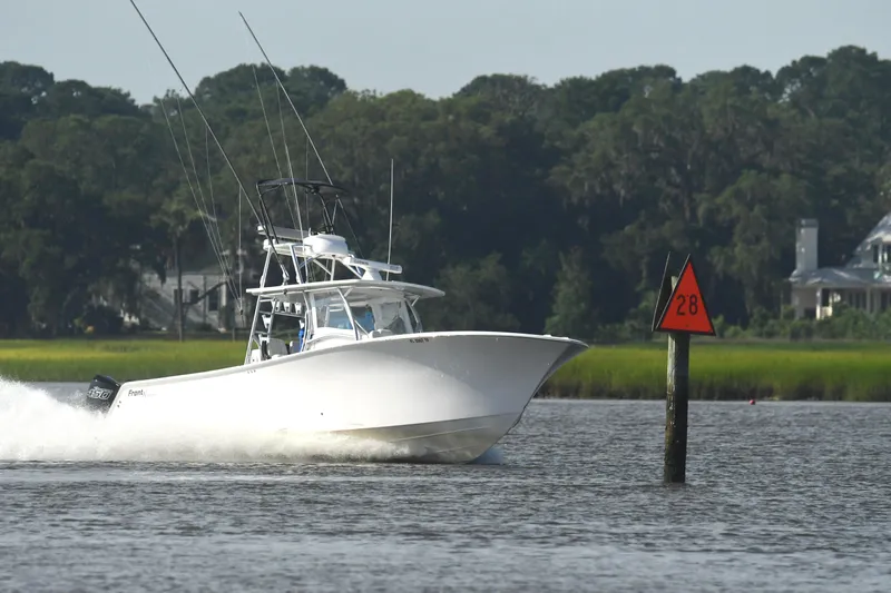 Yacht Photos Pics 2022 Front Runner 39 Center Console boat speeding on a river near a channel marker.