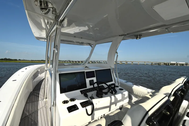  Yacht Photos Pics 2022 Front Runner 39 Center Console boat interior with dual screens, steering wheel, and seating.