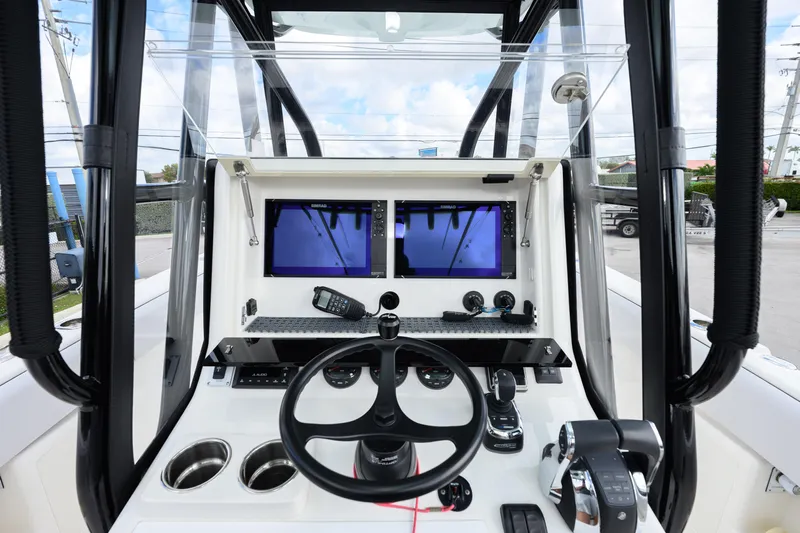 Seavee Yacht Photos Pics 2023 SeaVee 290B boat cockpit with dual screens and modern controls.