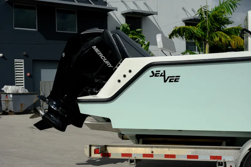 Seavee Yacht Photos Pics 2023 SeaVee 290B boat with Mercury engine on trailer, parked outdoors.