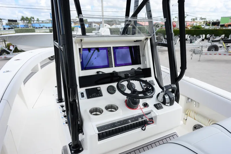 Seavee Yacht Photos Pics 2023 SeaVee 290B boat cockpit with modern navigation equipment and steering wheel.