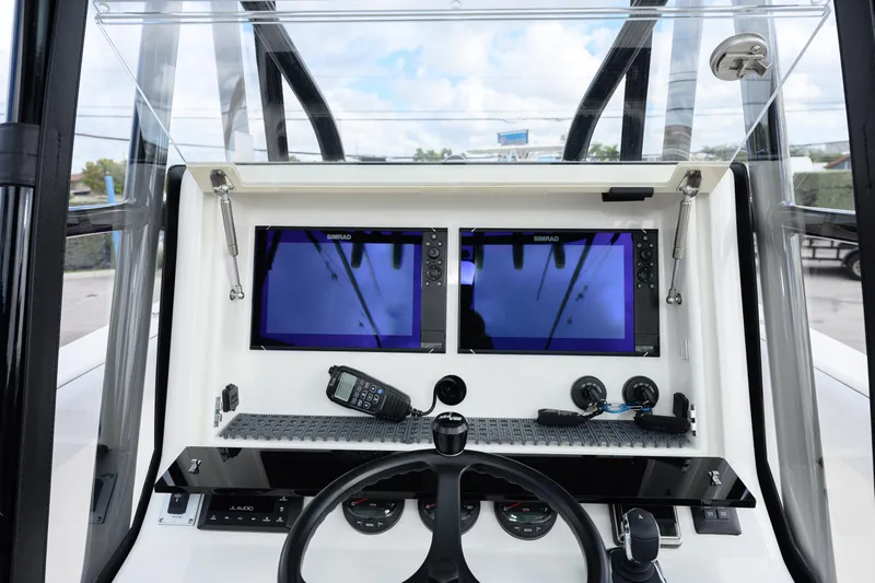 Seavee Yacht Photos Pics 2023 SeaVee 290B boat dashboard with dual Simrad displays and steering wheel.