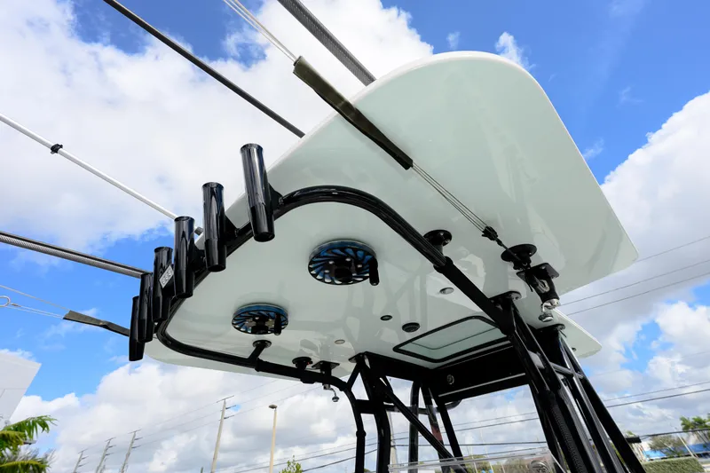 Seavee Yacht Photos Pics 2023 SeaVee 290B boat T-top with rod holders against a blue sky.