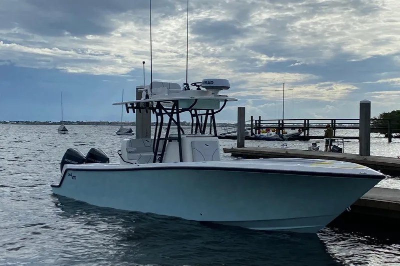 Seavee Yacht Photos Pics 2023 SeaVee 290B boat docked on a calm, cloudy day.
