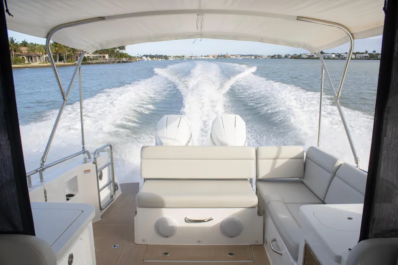  Yacht Photos Pics 2025 MJM 38 X boat cruising on water, view from rear seating area.