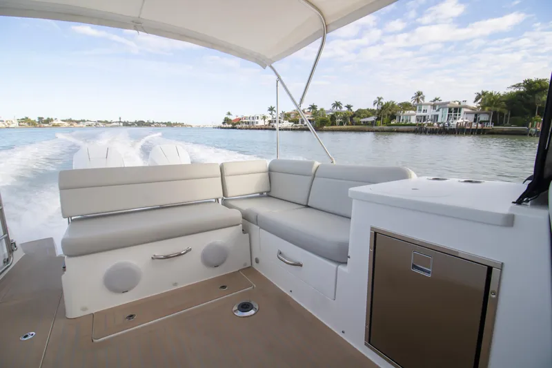  Yacht Photos Pics 2025 MJM 38 X boat interior with seating, cruising on a scenic waterway.