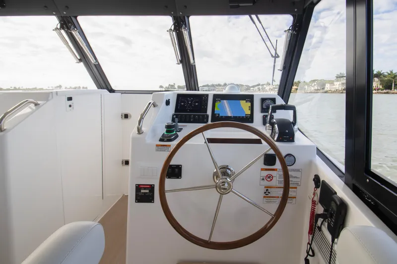  Yacht Photos Pics Helm of 2025 MJM 38 X boat with modern navigation equipment and steering wheel.