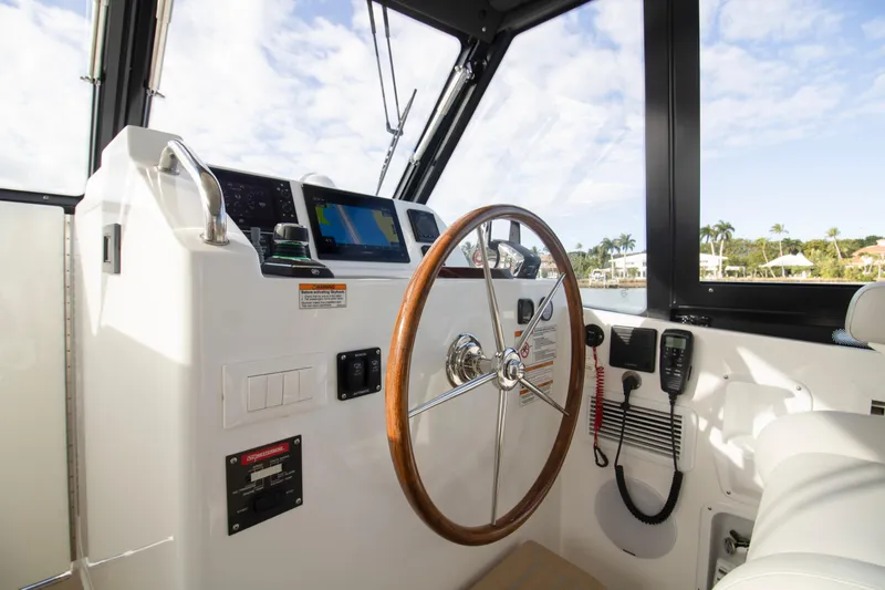  Yacht Photos Pics Helm of 2025 MJM 38 X boat with wooden steering wheel and navigation equipment.