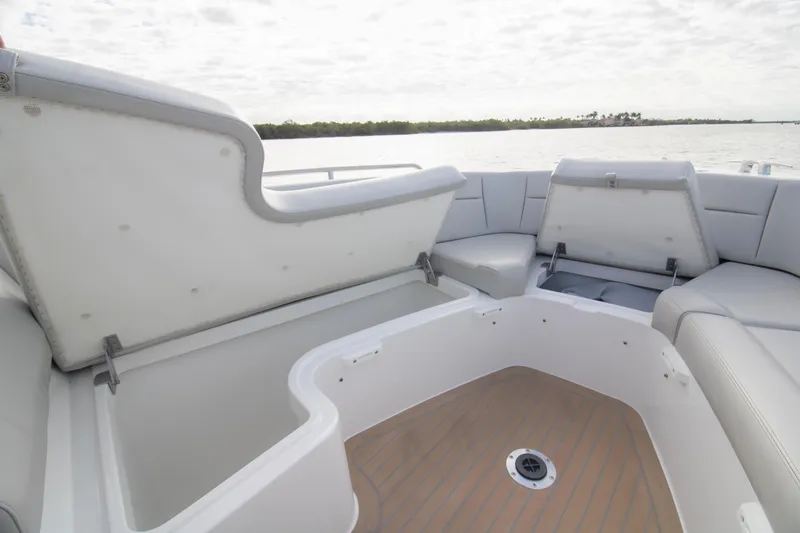  Yacht Photos Pics 2025 MJM 38 X boat interior with open storage compartments and cushioned seating.