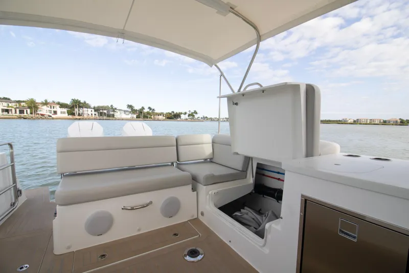  Yacht Photos Pics Luxury MJM 38 X 2025 boat interior with seating and storage, overlooking waterfront homes.