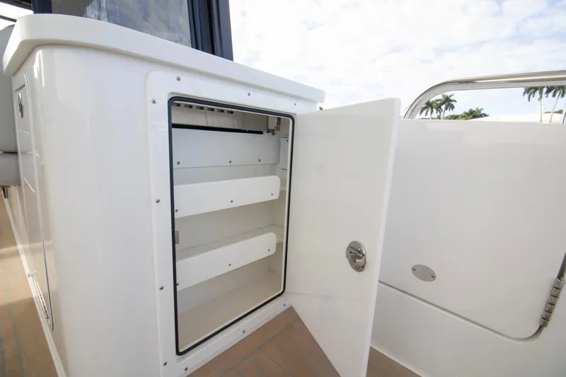  Yacht Photos Pics Open storage compartment on 2025 MJM 38 X boat, showcasing interior shelving.