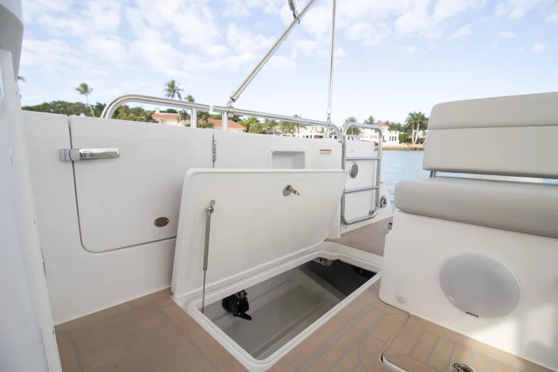  Yacht Photos Pics 2025 MJM 38 X boat deck with open storage compartment, luxurious seating, and scenic waterfront view.
