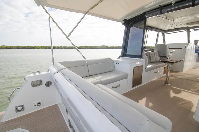  Yacht Photos Pics 2025 MJM 38 X boat interior with spacious seating and elegant design on calm waters.