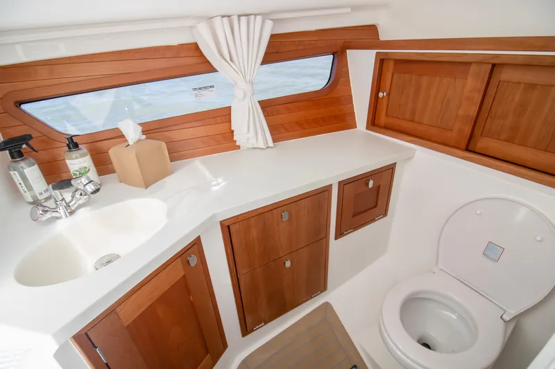  Yacht Photos Pics Luxurious bathroom interior of 2025 MJM 38 X yacht with wooden cabinetry and modern fixtures.