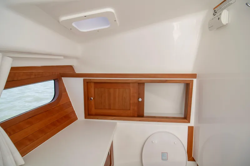  Yacht Photos Pics 2025 MJM 38 X yacht interior with wooden cabinetry and window.