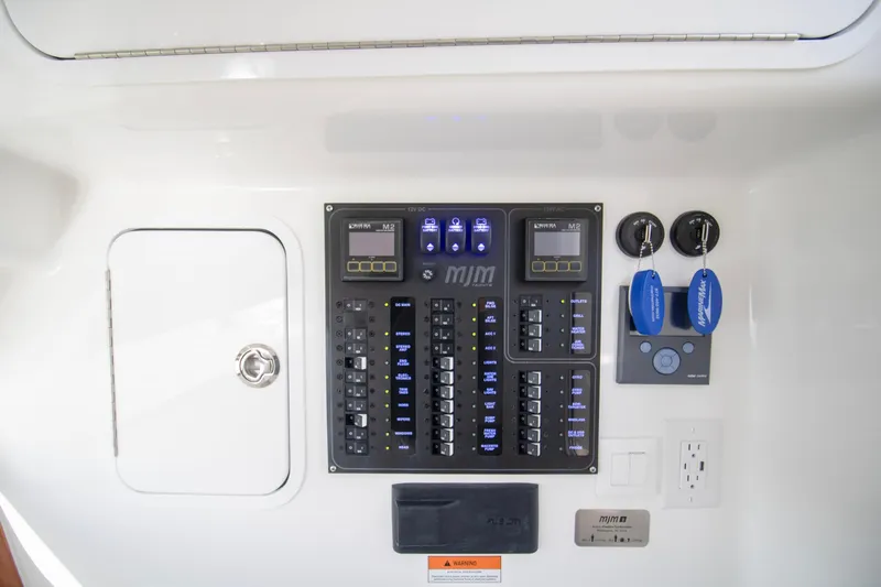  Yacht Photos Pics Control panel of 2025 MJM 38 X boat with switches and key fobs.