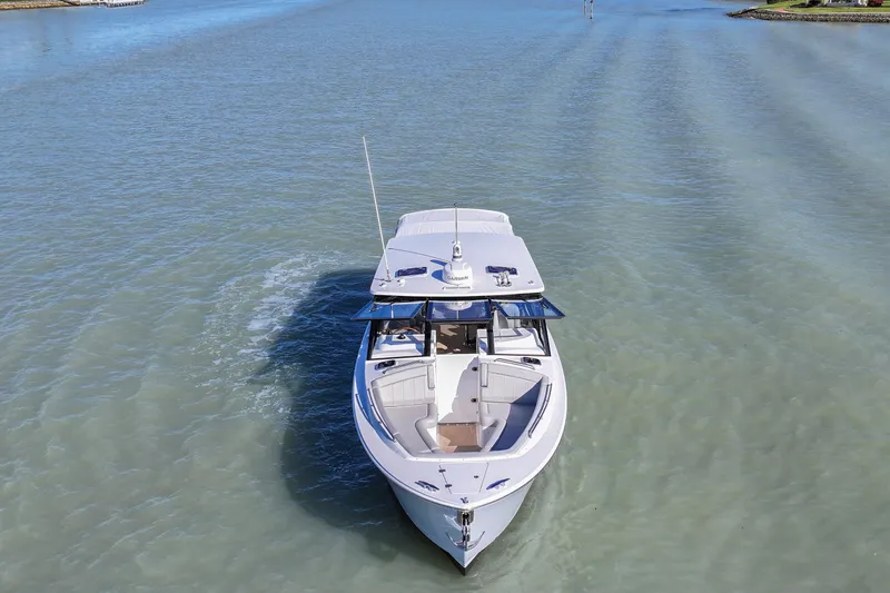  Yacht Photos Pics 2025 MJM 38 X boat cruising on calm waters, aerial view.