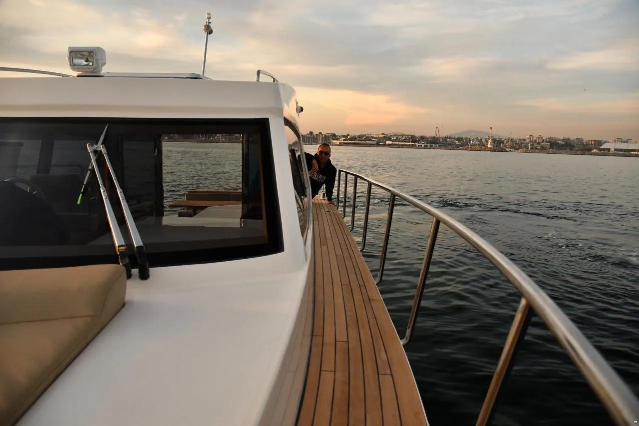 ERMAN YACHTING Comfort 36 cruising on calm waters at sunset.