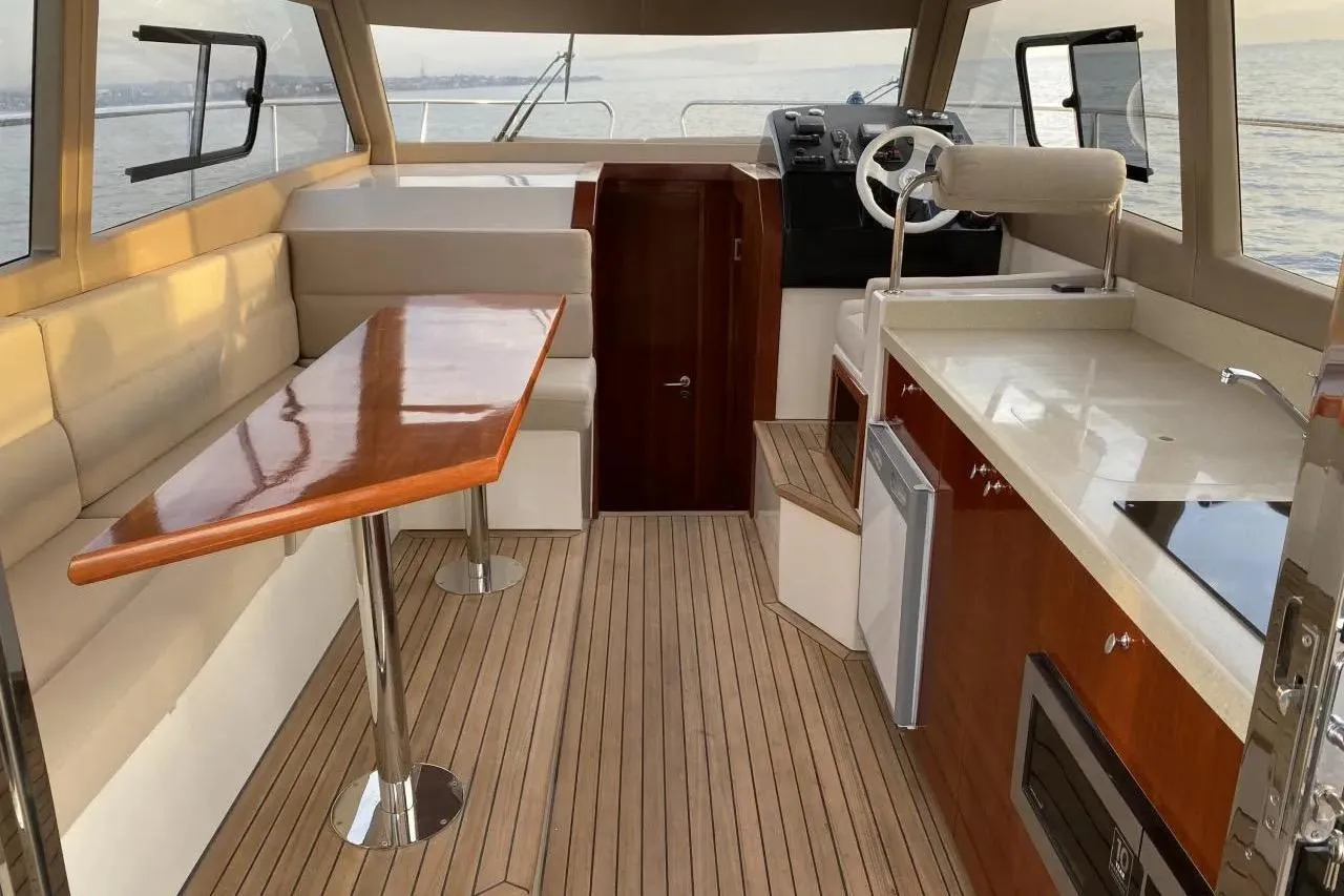 Luxurious interior of ERMAN YACHTING Comfort 36 with elegant seating and wooden finishes.