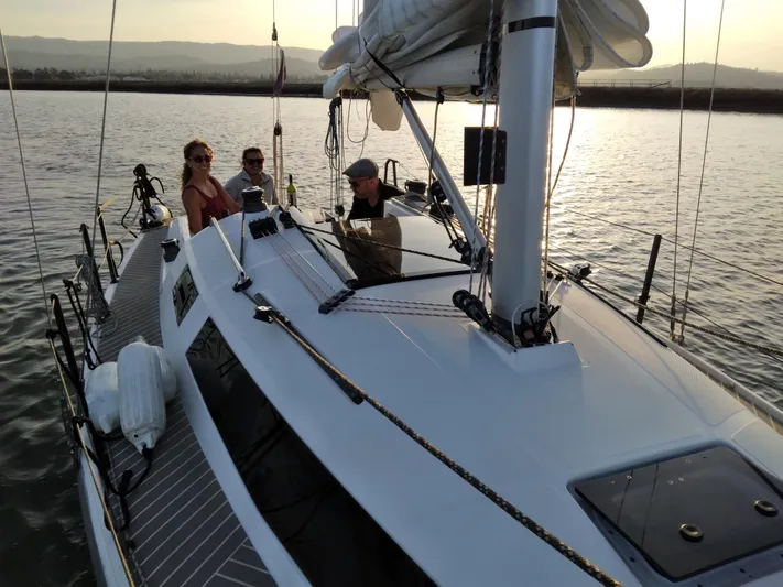  Yacht Photos Pics 2025 Faro Yachts 29 sailing with passengers on a serene waterway at sunset.