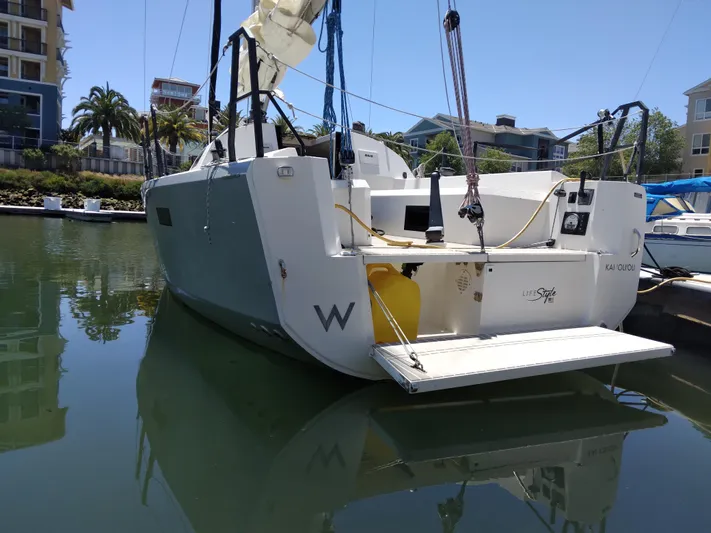  Yacht Photos Pics 2025 Faro Yachts 29 docked in a marina, surrounded by modern buildings and palm trees.