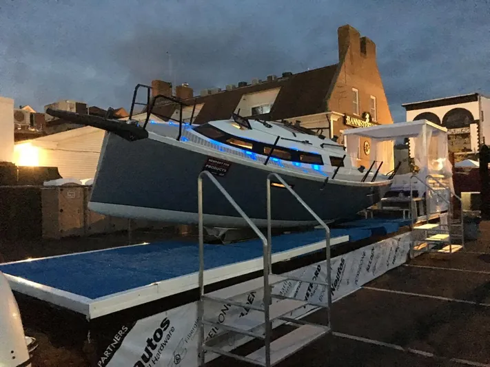  Yacht Photos Pics 2025 Faro Yachts 29 displayed on a platform at dusk, with blue accent lighting.