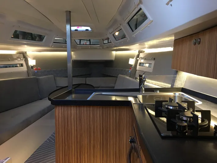 Yacht Photos Pics Luxurious interior of 2025 Faro Yachts 29, featuring modern kitchen and seating area.