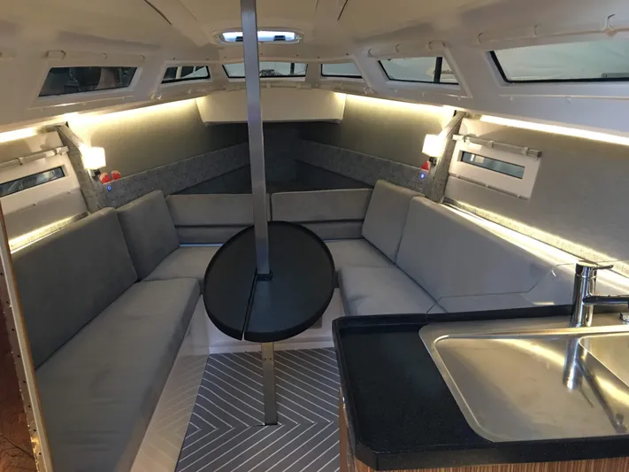  Yacht Photos Pics Luxurious interior of 2025 Faro Yachts 29, featuring modern seating and sleek kitchen area.