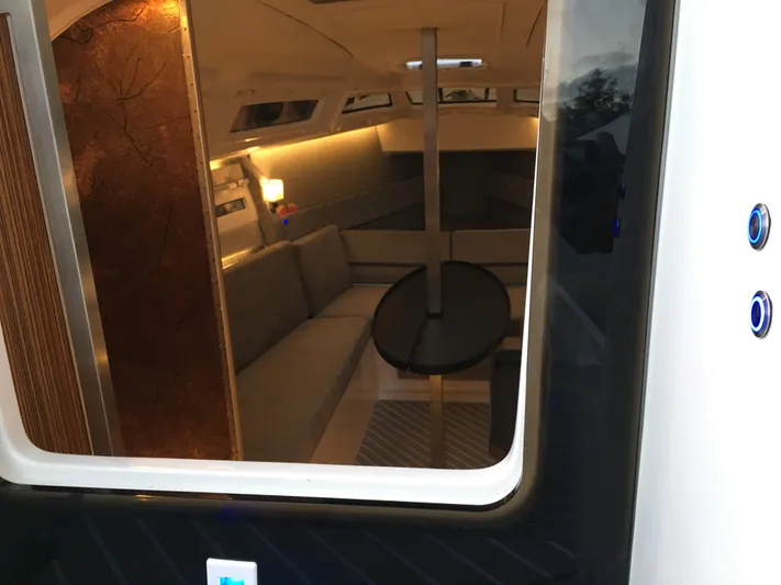 Yacht Photos Pics Interior view of 2025 Faro Yachts 29, featuring modern seating and ambient lighting.