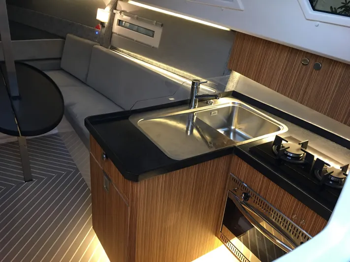  Yacht Photos Pics Modern kitchen interior of 2025 Faro Yachts 29, featuring sleek design and amenities.