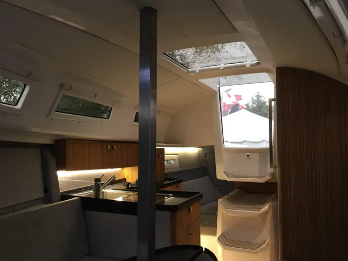  Yacht Photos Pics Interior of 2025 Faro Yachts 29, featuring modern kitchen and seating area.