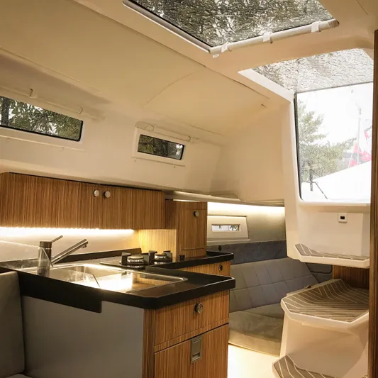  Yacht Photos Pics Luxurious interior of 2025 Faro Yachts 29, featuring modern kitchen and seating area.
