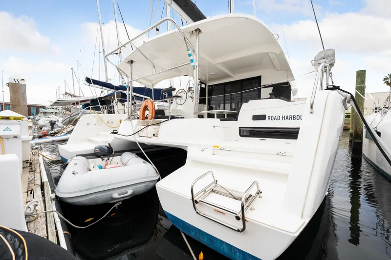 Aquaholic Yacht Photos Pics 2018 Lagoon 42 catamaran docked with inflatable dinghy.